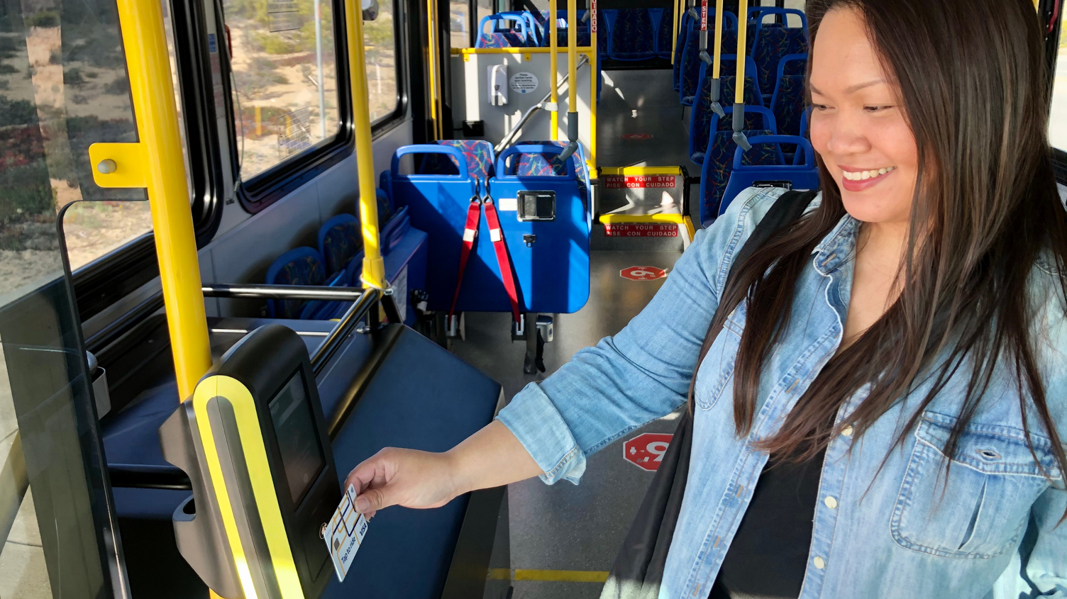 Rider onboard Monterey Salinas Transit bus using the new contactless payment system